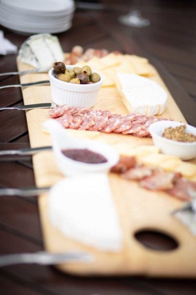 charcuterie board with meat, cheese and olives