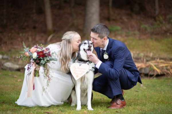 wedding couple kissing their dog